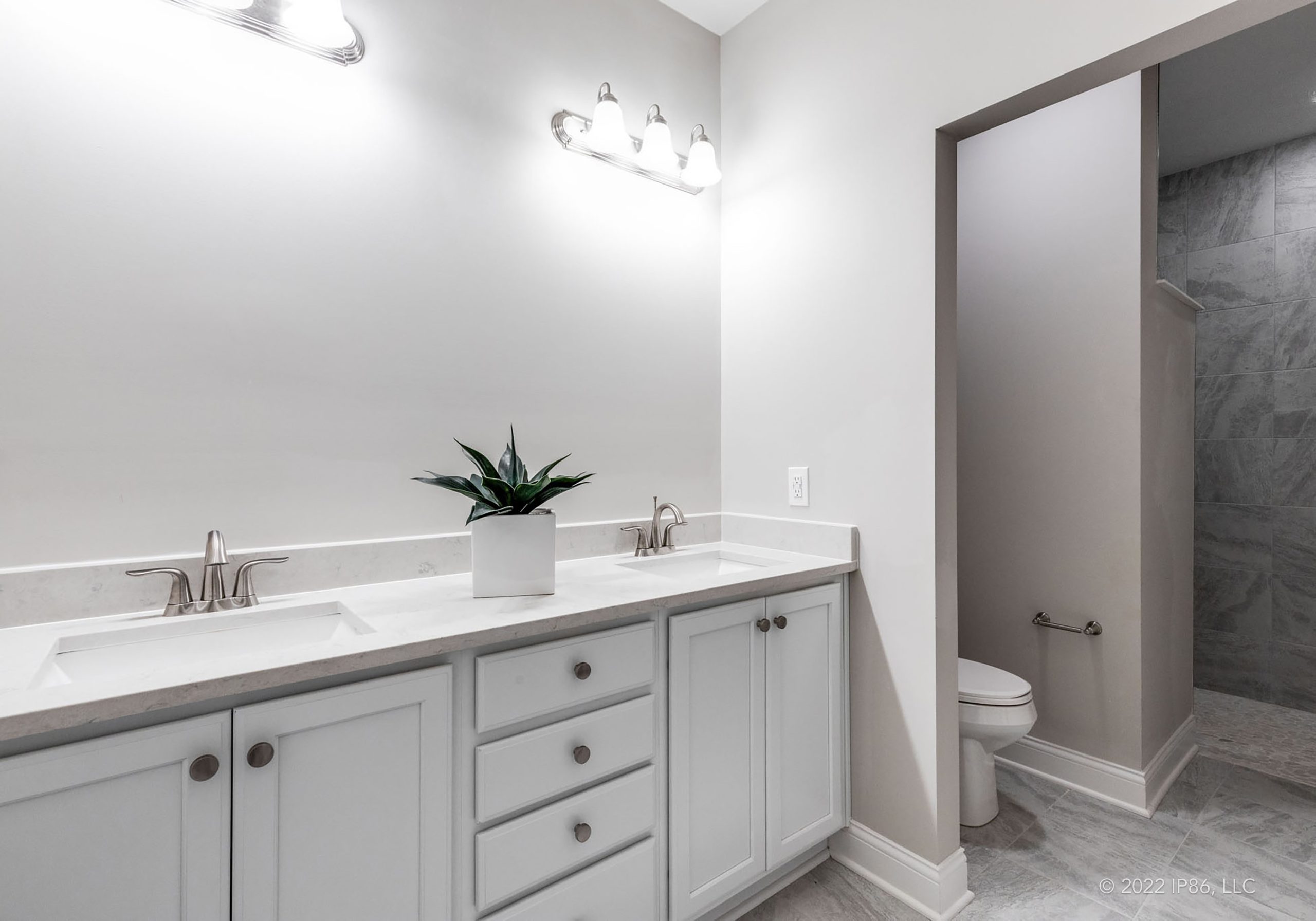 A modern bathroom featuring a shower and sink, designed as the Palazzo model by New Leaf Homes.